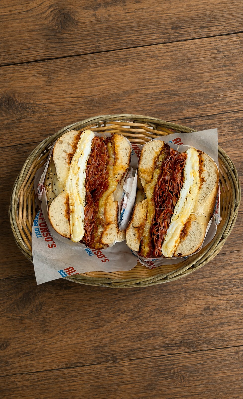 Breakfast bagels with egg, bacon and cheese, cut in half