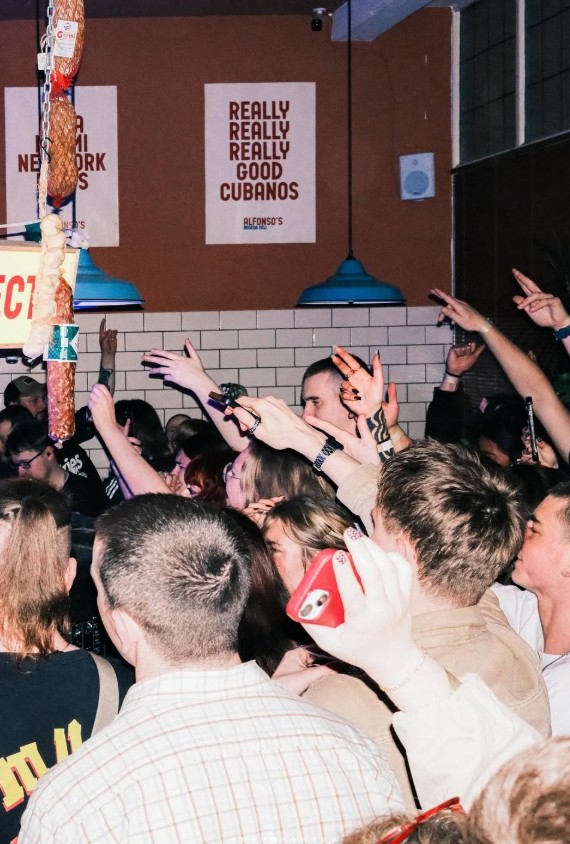 Packed crowd with hands up at an Alfonso's rave